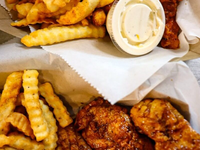 Cluckies chicken tenders with crinkle fries and Cluckies sauce